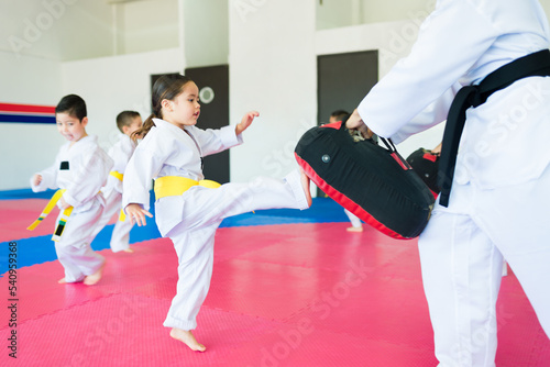 Beautiful kid learning martial arts techniques photo