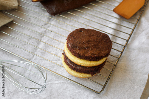 Freshly made homemade sponge cake shortcakes on metallic baking grid, photo