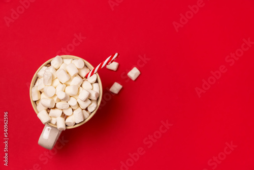 Mug with Hot Cocoa and Marshmallows on Red Background Concept for New Year's Drink Top View Copy Space