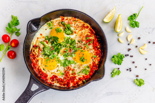 Shakshuka in a Pan Top Down Photo on White Background photo