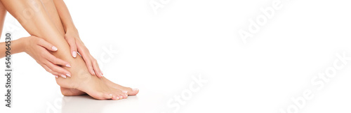 Perfect depilated woman legs on white background.