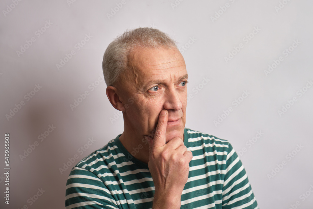 thoughtful senior man on gray background copy space thoughtful senior man on gray background copy space