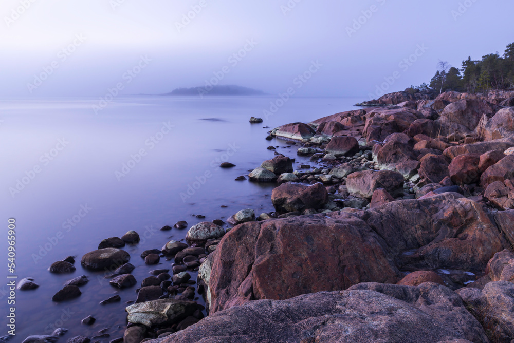 Rocky coast at sunset, Finland.