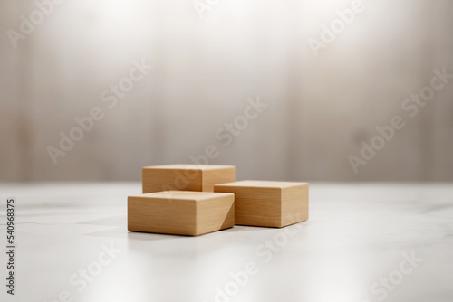 Fototapeta Naklejka Na Ścianę i Meble -  3D rendering of three wooden block stages on white marble table surface. Product advertisement template.
