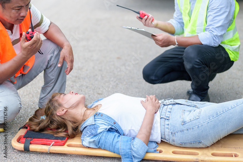 An injured woman in a plastic stretcher after a car accident ,Car accident insurance concept photo