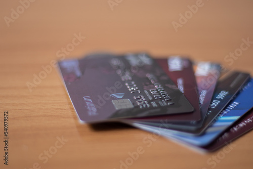Three credit cards put a spoon on the table.