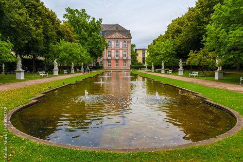 Picturesque view of the eastern part of the Palastgarten, the garden of the Electoral Palace in Trier, Germany. The pond is surrounded by white statues designed by Ferdinand Tietz. photo