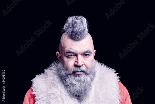 Severe dangerous Santa Claus with mohawk. Evil aggressive gray-haired old man Santa in a bad mood. New Year and Christmas in the company of an unusual bad Santa