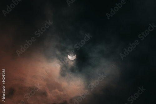 View of a partial solar eclipse in the sky. Ukraine, the city of Dnipro. Moon and sun. Daytime Eclipse October 25, 2022