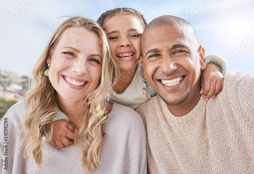 Mom, dad and girl in portrait with diversity, smile and multicultural together in sunshine outdoor. Woman, black man and girl on vacation, holiday or travel for happy, time and family in summer