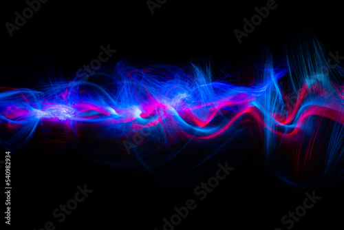 Abstract technology banner design. Long exposure, light painting. Vibrant streaks of digital neon lines on black background.