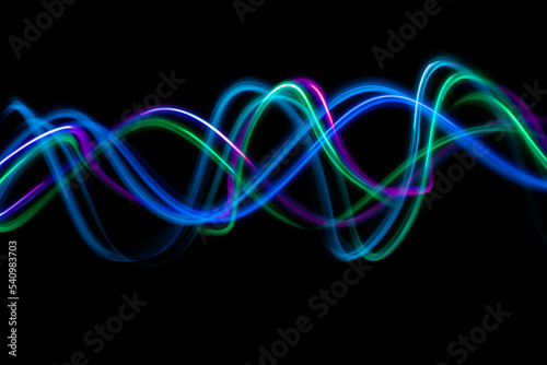 Abstract technology banner design. Long exposure, light painting. Vibrant streaks of digital neon lines on black background.