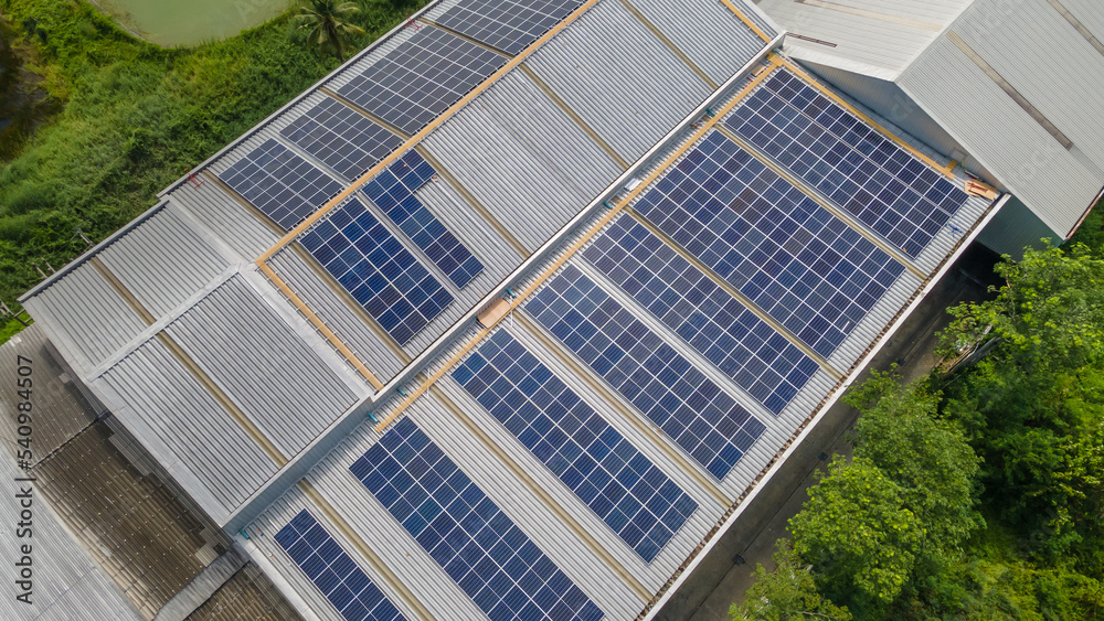 Solar panels installed on a roof of a large industrial building or a warehouse