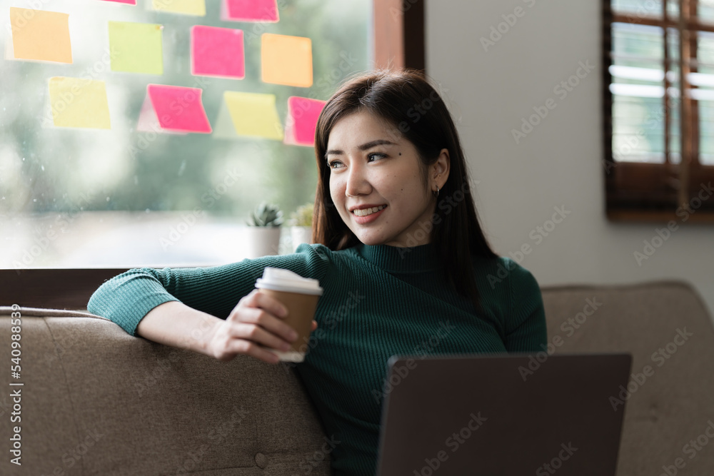 Portrait of asian beautiful young woman using laptop at home