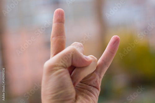 Hand gesture cool closeup on blurred background © aleksmark2016