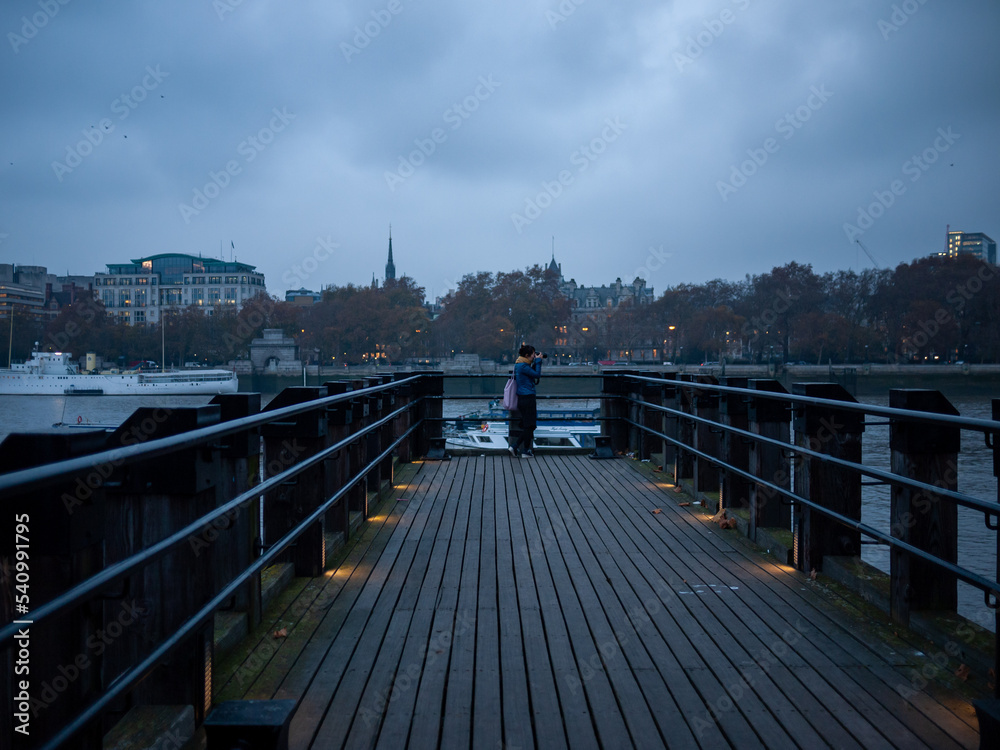 a girl on a  bridge over the river