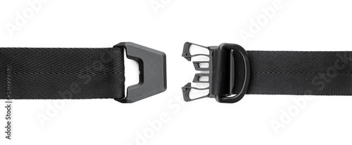 Black plastic fastener fastex for the manufacture of backpacks. Plastic belt clip, carbine - buckle, length adjusters on bag or backpack strap. Fastex buckle on textile belt on white background.