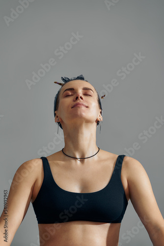 Pregnant Woman Stretching Arms And Legs, Doing Prenatal Workout At Home On Yoga Mat. Selective focus