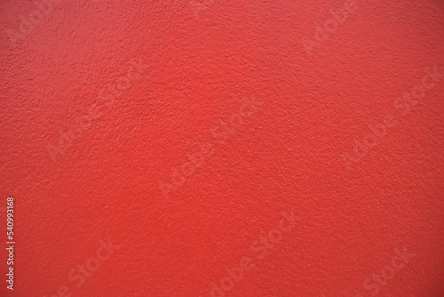 Cement red plaster wall have rough surface concrete. Red background abstract design are light with gradient background.