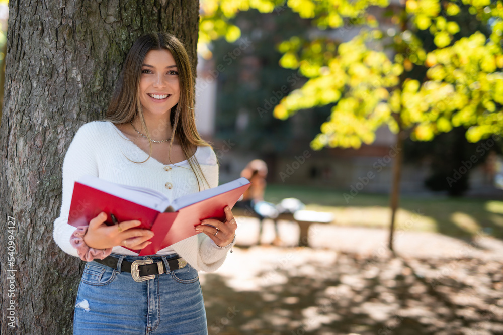 Female college student reading a book Female college student reading a book