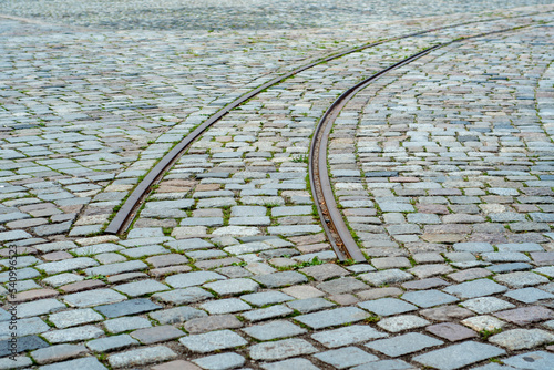 Rails passing through the paving stones in the city. Suddenly ending tram tracks. End of the journey. There is nowhere to move further.