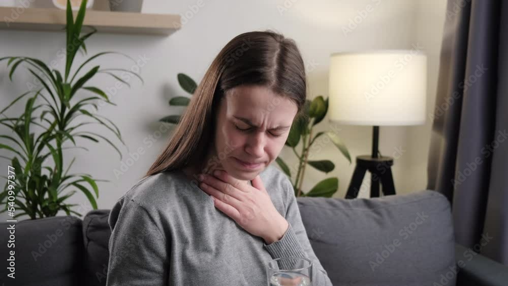 Close up of unhealthy young woman have sore throat cough symptom and