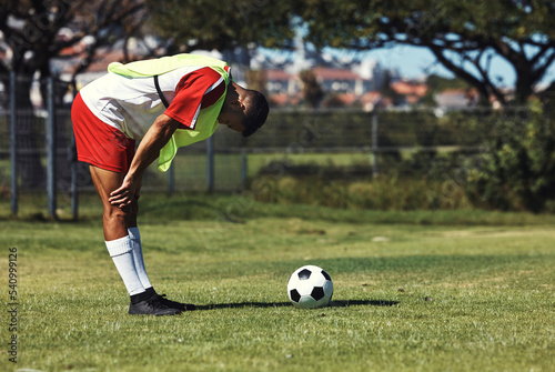 Fototapeta Naklejka Na Ścianę i Meble -  Man, tired and soccer ball on field in training, warmup or workout outdoor in summer. Exercise, soccer player and rest by football on grass in sunshine for sport, health or performance in development