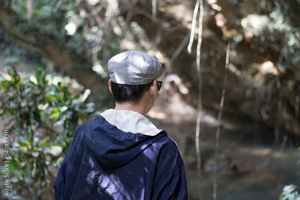 Portrait of a man turning one's back on, walking, sightseeing, and in the forest with weekend enjoyment. Portrait of a man turning one's back on, walking, sightseeing, and in the forest with weekend enjoyment.