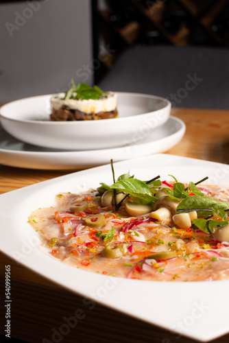 Fish carpaccio. Finely sliced ​​fish. Tuna and needle fish. Garnished with Olive Oil and Capers
