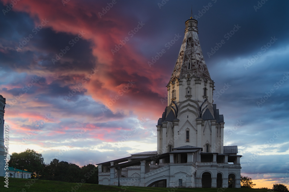 Church of the Ascension in Kolomenskoye Park at dramatic sky in the sunset. Moscow, Russia. Famous place and tourist attraction