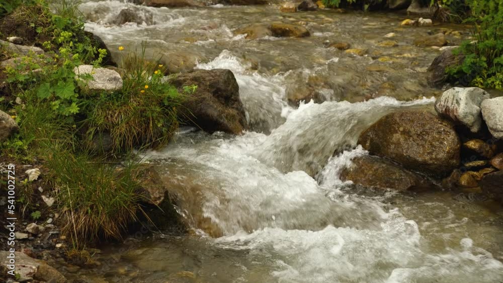 Close-up of clear mountain water rushing down a rocky bed. Melt water from glaciers forming rivers. The beauty of wildlife. Background video Close-up of clear mountain water rushing down a rocky bed. Melt water from glaciers forming rivers. The beauty of wildlife. Background video