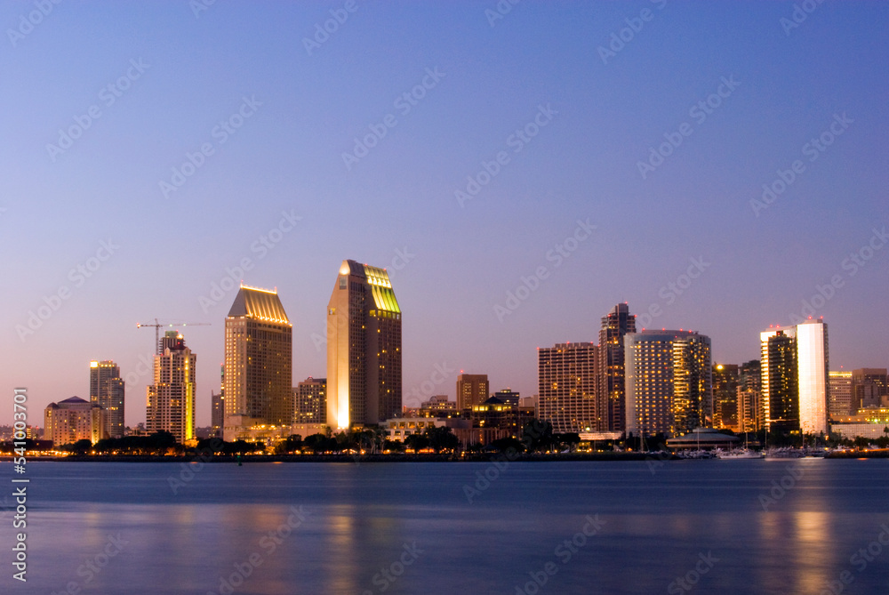 The San Diego skyline is illuminated at dusk as seen from Coronado Island, CA. The San Diego skyline is illuminated at dusk as seen from Coronado Island, CA.