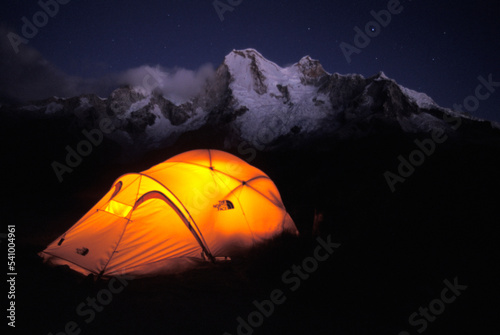 A tent glowing under the stars in Cordillera Blanca, Peru. photo