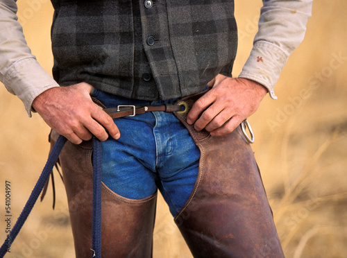 A cowboy with his hands on his chaps in Bishop, California. photo
