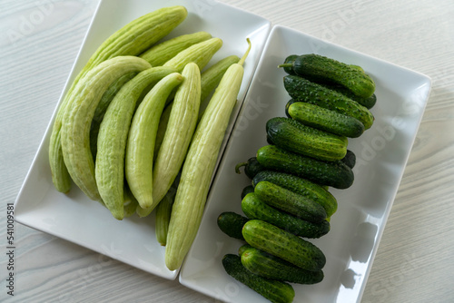gherkin and armenian cucumber on white table