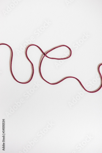 abstract white background with dark red string