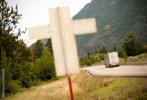 A white cross signifying a death along a dangerous highway. photo