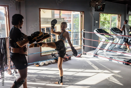 Young woman practicing kickboxing with coach, Seminyak, Bali, Indonesia