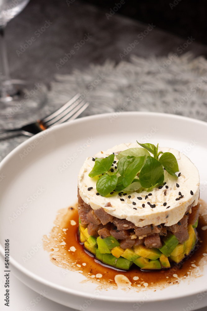 Tuna tartar. Tuna cut into small cubes mixed with soy and spicy and avocado bed
Tuna tartar. Tuna cut into small cubes mixed with soy and spicy and avocado bed