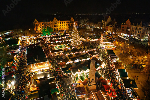 Traditional Christmas market in Erfurt  Thuringia in Germany. With xmas tree  pyramide and sales and food stands on late evening or night.