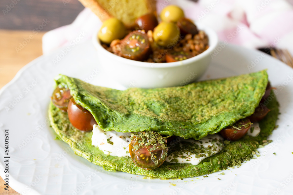 Spinach pancakes with cheese and cherry tomatoes with lentil salad. Ready-to-eat vegetarian food Spinach pancakes with cheese and cherry tomatoes with lentil salad. Ready-to-eat vegetarian food