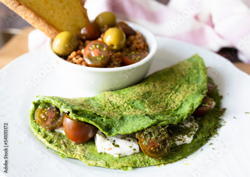 Spinach pancakes with cheese and cherry tomatoes with lentil salad. Ready-to-eat vegetarian food