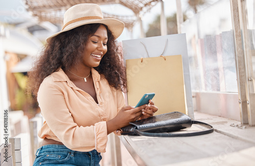 Shopping bag, phone and black woman on mobile for social media, fashion or happy with 5g app. Beauty, luxury and wealthy girl with smartphone for ecommerce payment onilne while on holiday in miami © Anela R/peopleimages.com