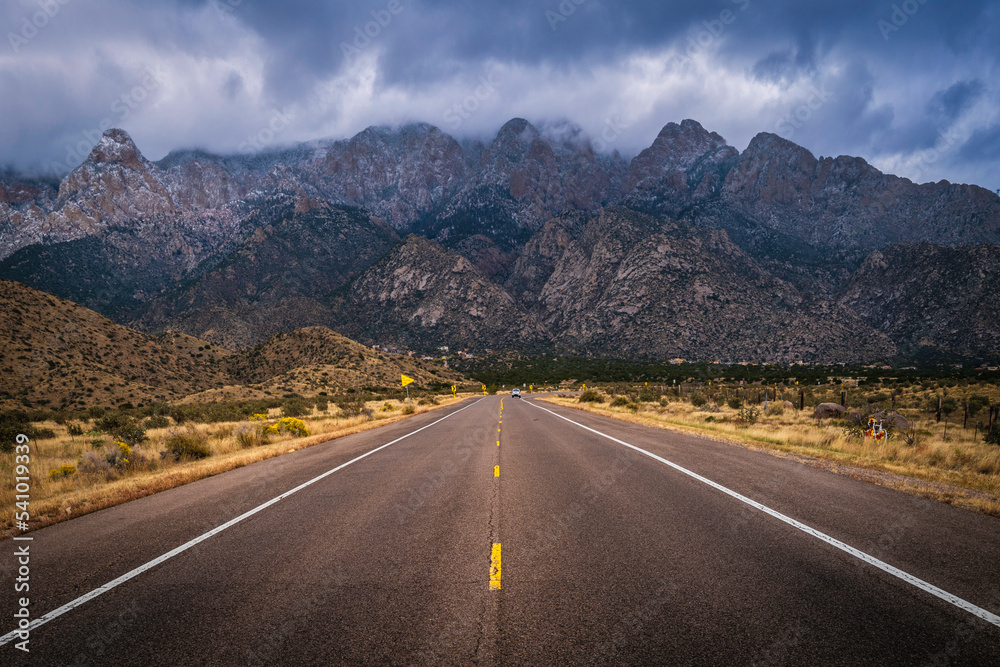 The entrance road to the Sandia Peak Tramway with dramatic snow and clouds in Albuquerque, New Mexico, USA The entrance road to the Sandia Peak Tramway with dramatic snow and clouds in Albuquerque, New Mexico, USA