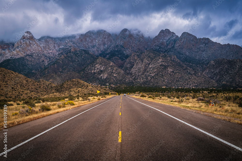 The entrance road to the Sandia Peak Tramway with dramatic snow and clouds in Albuquerque, New Mexico, USA