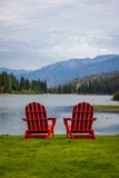 Two Red Chairs Overlooking Water and Mountains
