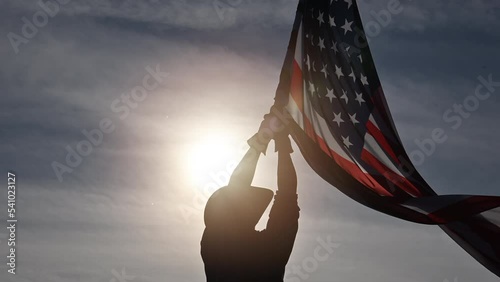 Man Shows Love of Country by Waving American Flag