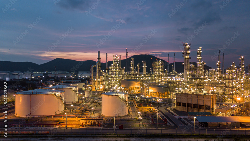 Aerial view oil storage tank and oil refinery factory plant at night form industry zone, Oil refinery and petrochemical plant factory at night, Business oil and gas industrial factory power and energy