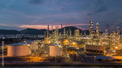 Aerial view oil storage tank and oil refinery factory plant at night form industry zone  Oil refinery and petrochemical plant factory at night  Business oil and gas industrial factory power and energy