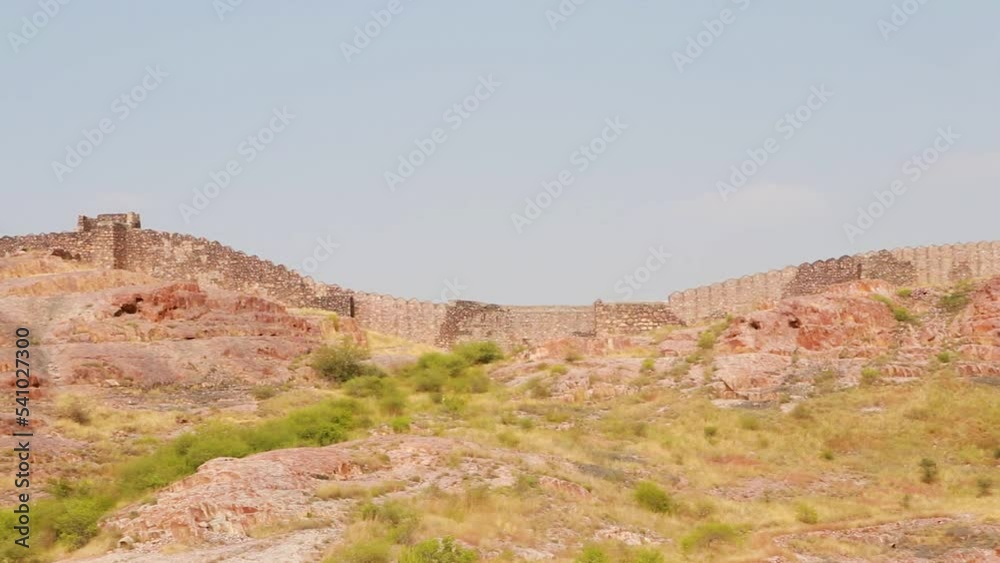 ancient stone wall at mountain top with blue sky from flat angle